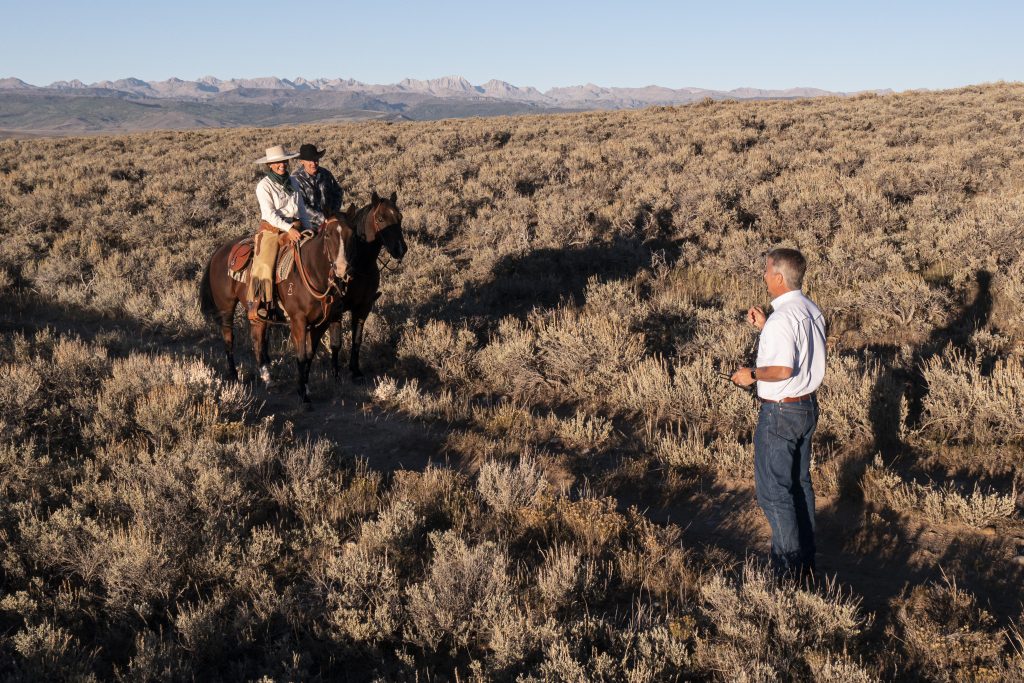 real estate broker latham jenkins giving property tour on horseback