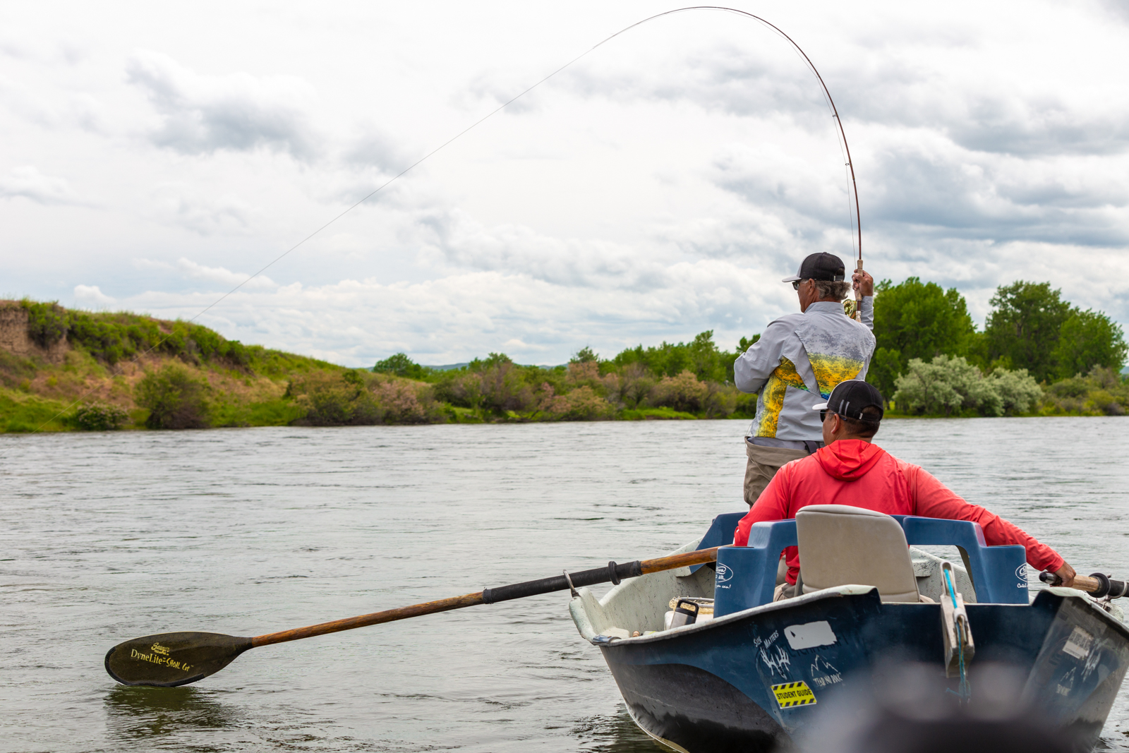 fly fishers in a boat on the river
