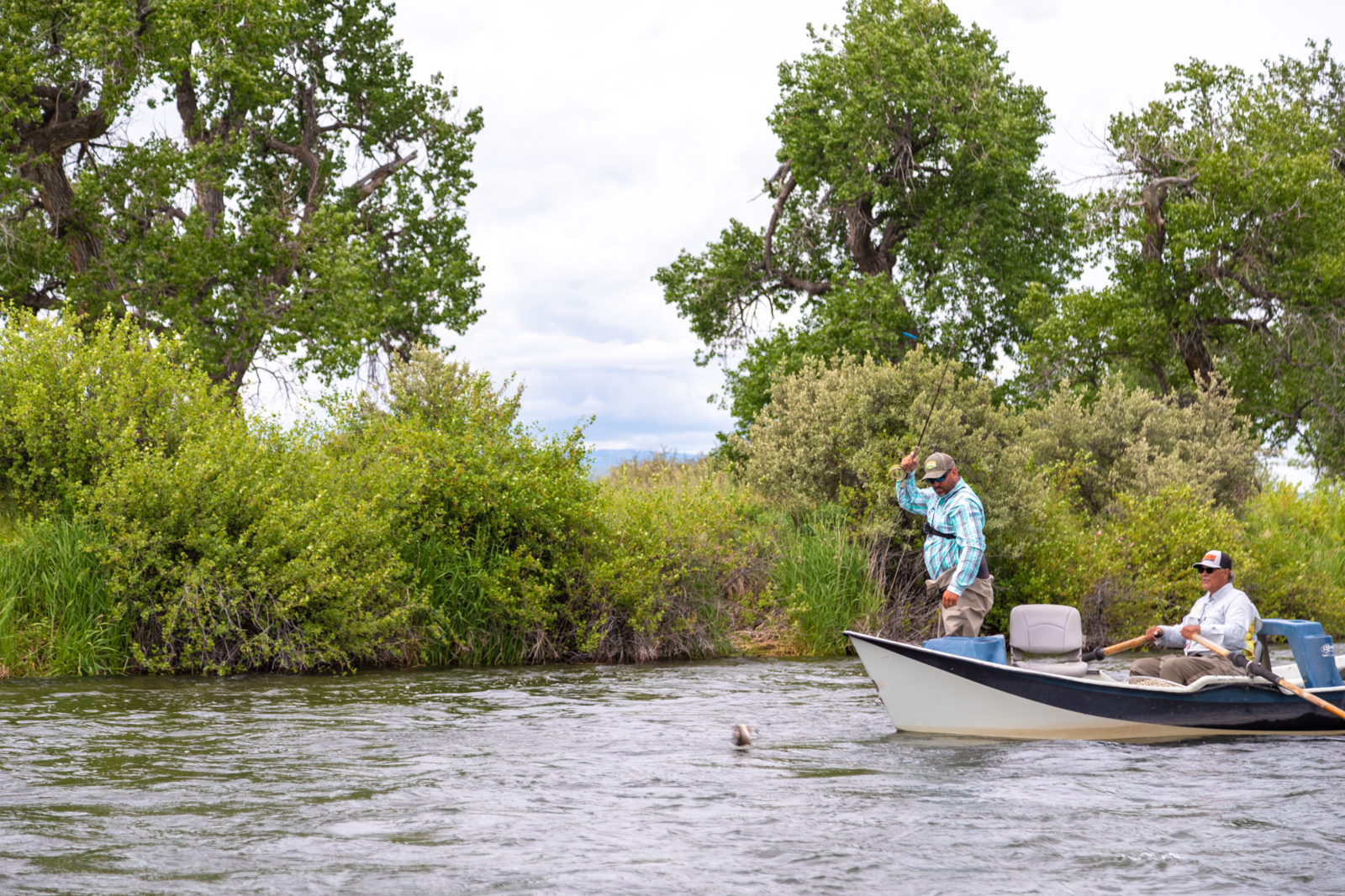 fly fisher fishing in a boat