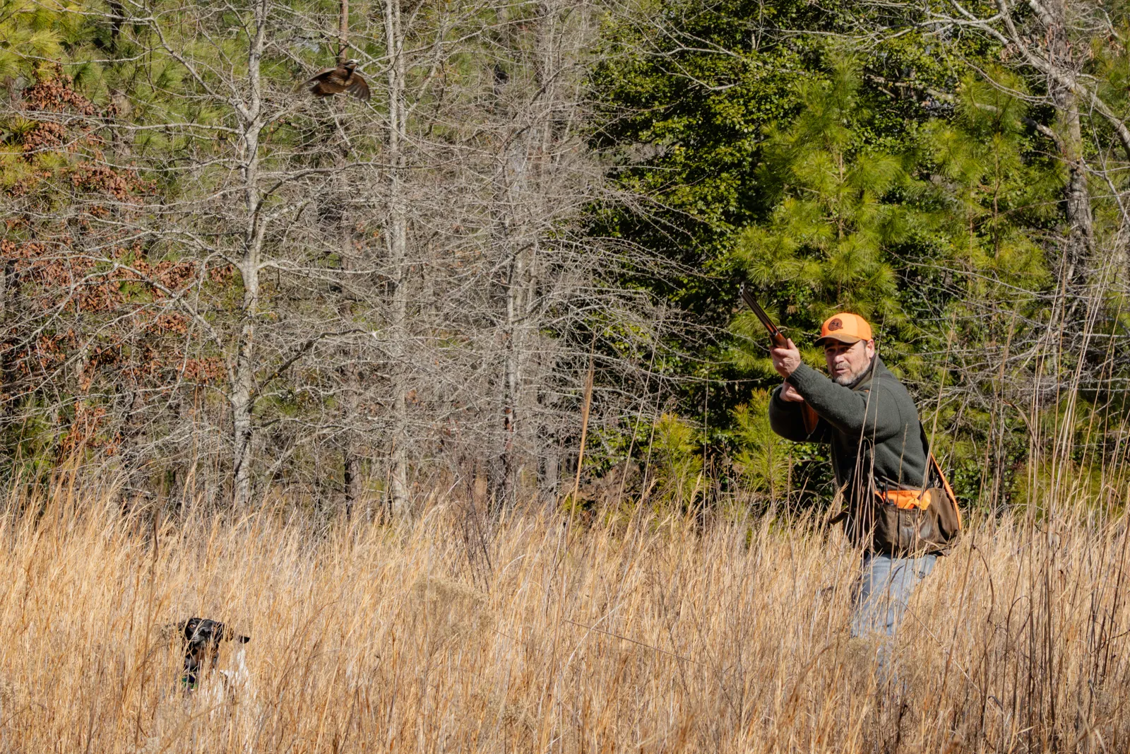 man shooting shotgun